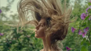 femme relevant la tête cheveux en l'air dans la nature